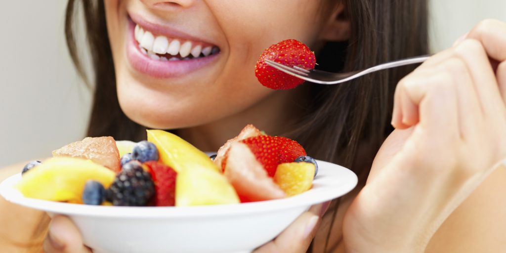 Woman eating fresh fruit